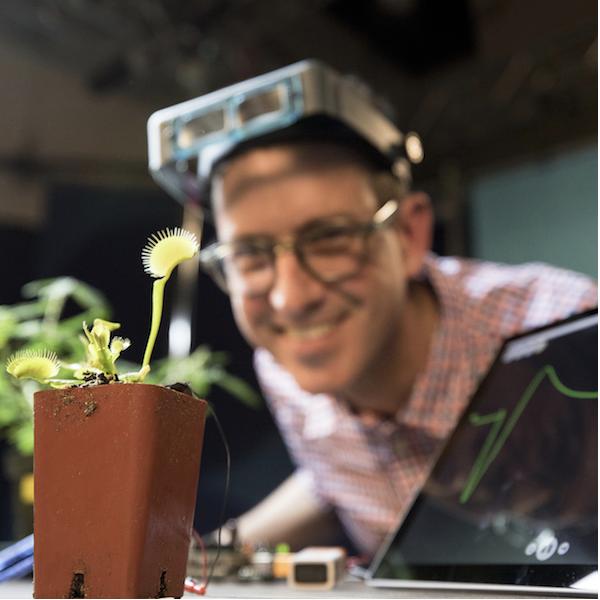 Greg Gage with a Venus flytrap and a live recording on a laptop