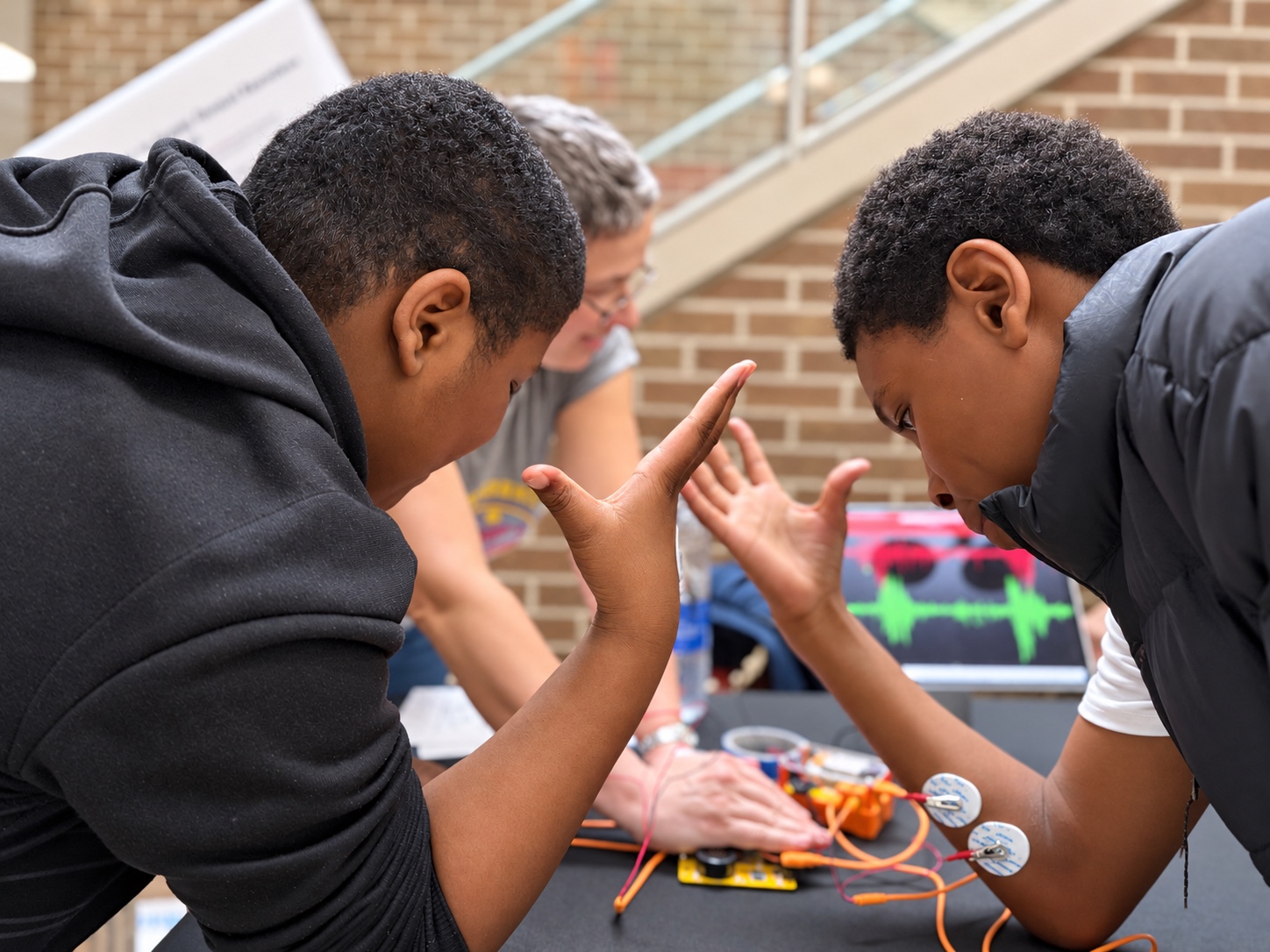 Two students testing the Human-Human Interface with Backyard Brains equipment